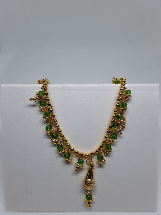 Goldtone green-beaded necklace and earring set