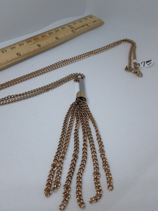 Goldtone necklace with a flowing chain pendant