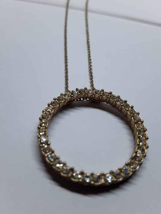 Goldtone necklace with rhinestone circle pendant