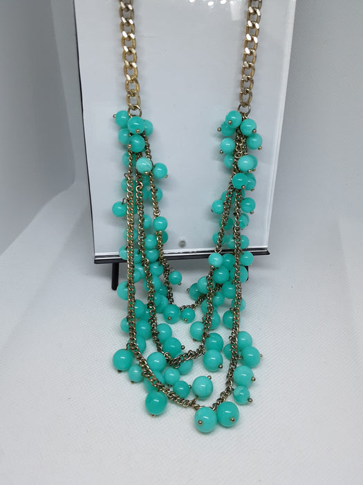 Goldtone necklace with greenish blue beads