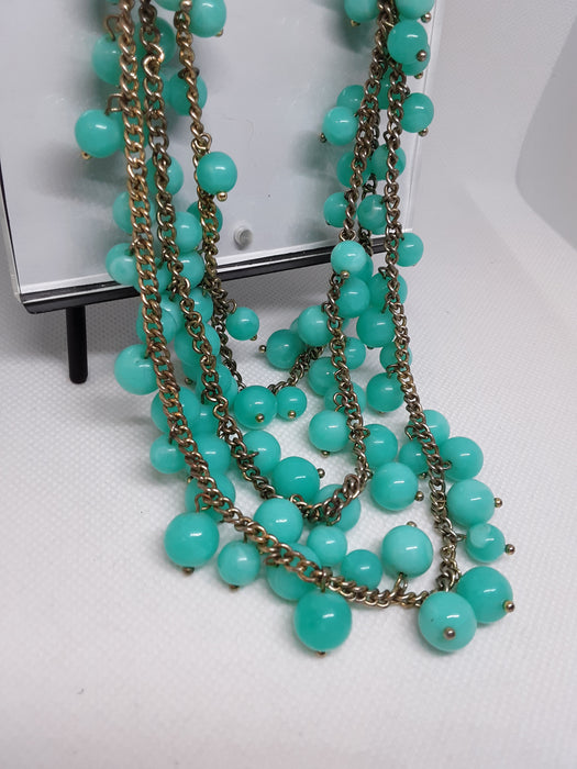 Goldtone necklace with greenish blue beads