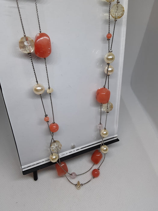 Silvertone necklace with melon colored beads